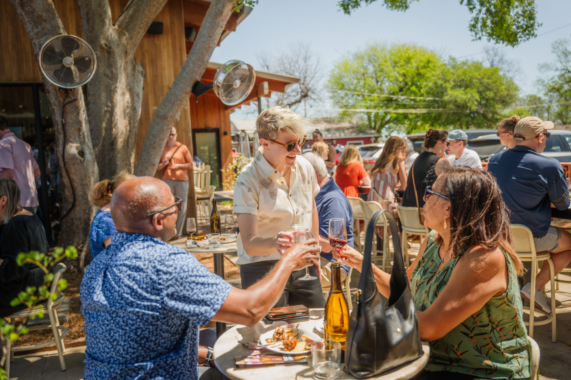 Guests toasting with La Valentía wine under the oaks at the Spring 2026 release party