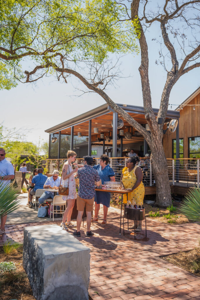 Guests on the brick patio at the La Valentía spring 2026 release party