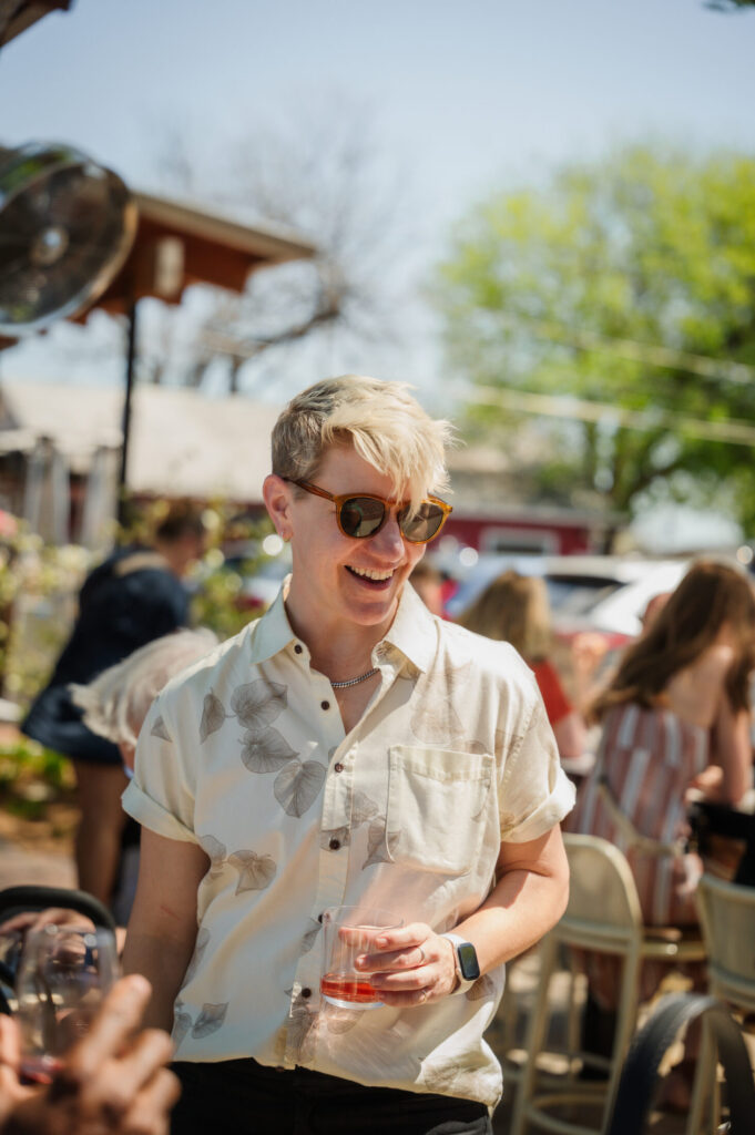 Winemaker Rae Wilson laughing with guests at the Spring 2026 release party