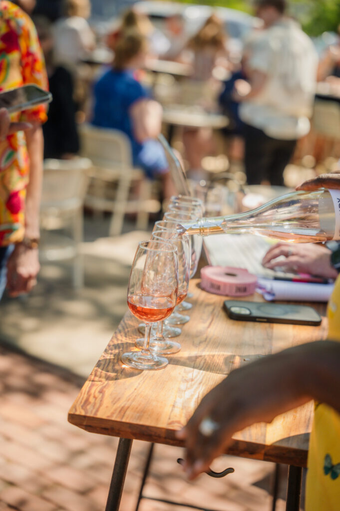 A flight of La Valentía rosé poured on a reclaimed wood table